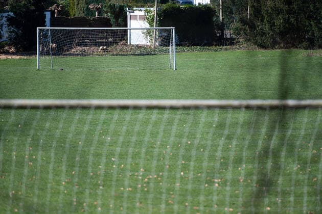The corona virus Covid 19 causes events such as professional and amateur soccer matches to be cancelled indefinitely, with many consequences, in the picture A blocked and empty sports field with soccer goals Germany
