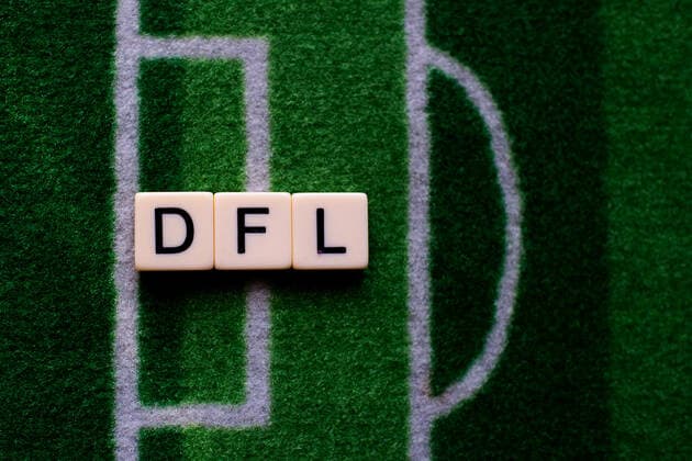 The corona virus Covid 19 causes events such as Bundesliga football matches to be cancelled indefinitely and has many consequences, in the picture The word DFL on a football carpet The German Football League is faced with decisions on how to continue to play Germany