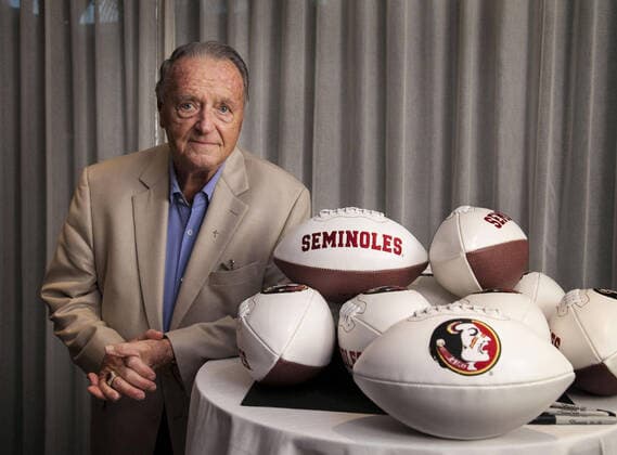 March 25, 2020, USA: Former Florida State University football coach Bobby Bowden stands with a pile of footballs he was signing for the Fellowship of Christian Athletes dinner at the PGA, Golf Herren National Resort in Palm Beach Gardens in 2014. USA - ZUMAm67_ 20200325_zaf_m67_024 Copyright: xRichardxGraulichx