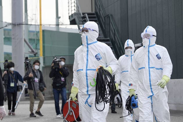 Hanshin Tigers player to take coronavirus test Officials in protective gear prepare to disinfect facilities for the Hanshin Tigers in Nishinomiya, Hyogo Prefecture, western Japan, on March 26, 2020 after one of its players developed symptoms of the new coronavirus. The Nippon Professional Baseball team said he will take a virus test. 