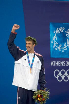 Swimming Michael Phelps (USA) reacting with his gold medal for the 400m IM where he also broke his own world record_2004 Olympic Summer Games, Athens, Greece. August 14, 2004. Athens Greece Copyright: xPaulxJxSutton PCNx SW1217 106083