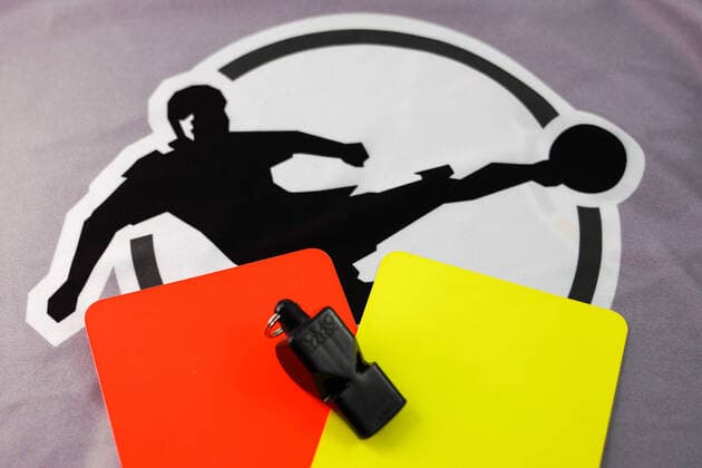 What should happen to football in the 3 League due to the difficult situation with the coronavirus, continue or end the season, the photo shows the logo of the 3 League as well as a red card, a yellow card and a referees whistle on a grey body, league logo and lettering, symbol photo, symbol image, symbol, 22 04 2020, Heidelberg Germany , Feature, Football, Symbol images of the 3 League xozx