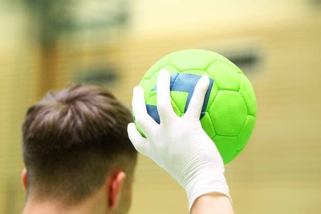 Hygiene in times of coronavirus A hand in disposable gloves on a handball Handball in the Coronakrise Handball in the Coronakrise Limburg Copyright: xWeissx Eibner-Pressefotox EP_rws