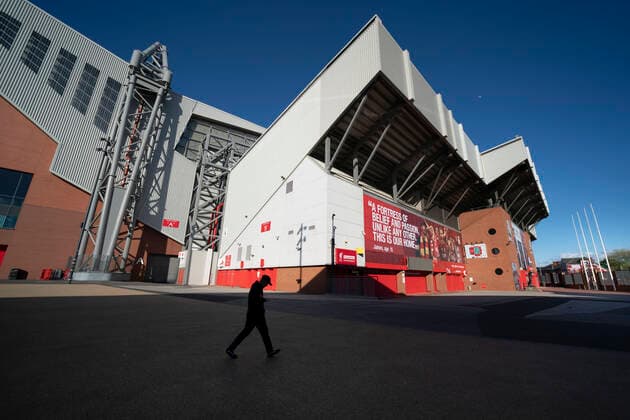 (200503) -- LIVERPOOL, May 3, 2020 -- A man walks past Liverpool Football Club s Anfield Stadium as events continue to be suspended during the COVID-19 pandemic in Liverpool, Britain, May 2, 2020. (Photo by Jon Super Xinhua) (SP) BRITAIN-LIVERPOOL-COVID-19-PREMIER LEAGUE HanxYan 