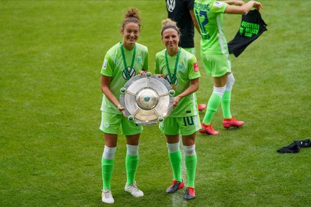 WOLFSBURG, GERMANY, JUN 28: Felicitas Rauch and Svenja Huth pose with the trophy after the team s championship victory during the Womens Bundesliga football match between VfL Wolfsburg and Bayer 04 Leverkusen. Daniela Porcelli SPP VfL Wolfsburg v Bayer 04 Leverkusen 