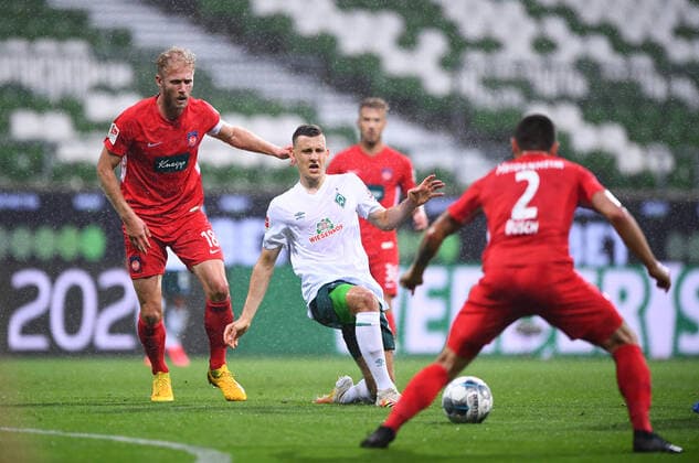 Werder Bremen 1 FC Heidenheim football, relegation, Werder Bremen 1 FC Heidenheim duel Maximilian Eggestein Bremen against Marnon Busch Heidenheim r and Sebastian Griesbeck Heidenheim l Photo Marvin Ibo Güngör GES Pool via xim gs DFL regulations prohibit any use of photographs as image sequences and or quasi video Editorial use only National and international news agencies out Bremen Germany Poolfoto Marvin Ibo Güngör GES Pool via xim.gs ,EDITORIAL USE ONLY