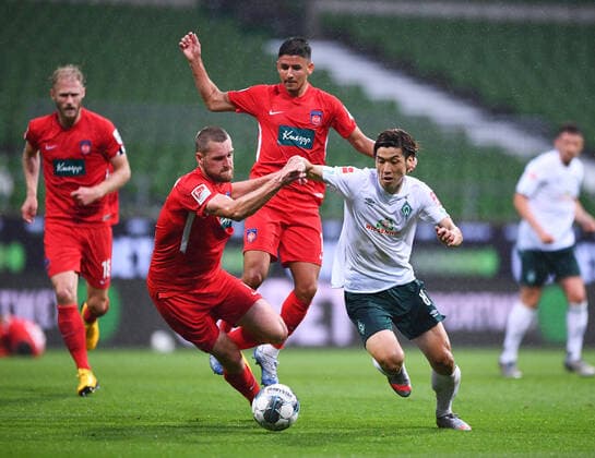 Werder Bremen 1 FC Heidenheim football, relegation, Werder Bremen 1 FC Heidenheim duel, duel Yuya Osako Bremen against Kevin Sessa Heidenheim and Patrick Mainka Heidenheim Photo Marvin Ibo Güngör GES Pool via xim gs DFL regulations prohibit any use of photographs as image sequences and or quasi video Editorial use only National and international news agencies out Bremen Germany Poolfoto Marvin Ibo Güngör GES Pool via xim.gs ,EDITORIAL USE ONLY