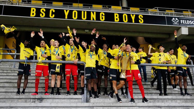 Photo Manuel Geisser 03 8 2020 Bern Wankdorf Stadium Season 2019 2020 Mens Football Super League BSC Young Boys Bern FC St Gallen Players celebrate with cup on the standing ramp of YB fans Guillaume Hoarau and goalkeeper Marco Wölfli with cup BSC Young Boys Bern Swiss Champion 2019 2020