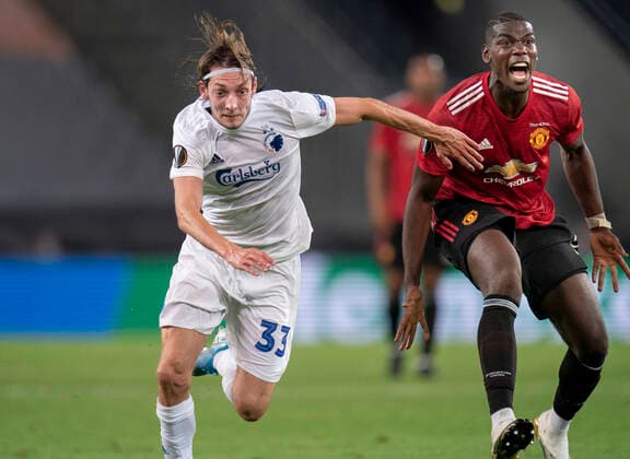 Bilder des Jahres 2020, Sport 08 August Sport Themen der Woche KW33 FCKs Rasmus Falk og Manchester Uniteds Paul Pogba under Europa League kampen mellem FCK Manchester United, ManU paa RheinEnergieStadion i Koeln mandag den 10 august 2020.. , Koeln Tyskland  Copyright: Ritzau Scanpix LiselottexSabroex COP102 spdk20200810-225953-L