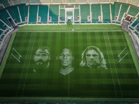The pitch at Twickenham Stadium has been transformed into a stunning portrait featuring three of Premiership Rugby?s star players today (12th August 2020). The giant rugby art, the largest outdoor painting ever created in the UK, was unveiled to celebrate the restart of Gallagher Premiership Rugby on Friday 14 th August when Harlequins take on Sale Sharks at 7:45pm, just 200 metres away. The artwork features Harlequins player, Joe Marler; Saracens? Maro Itoje, as well as Sale Sharks? Rugby World Cup winner Faf de Klerk. It took team of eight artists more than 24 hours to complete the pitch portrait and more than 100 hours of planning before any paint touched the grass. A bespoke computer program was written to generate the precise measurements that were needed to create the artwork to the exact scale of the stadium. The image, which occupies most of the 7,000 square metre pitch, was created using a grid comprised of 13,420 elements. Each painted line in the portrait is just 6 inches wide. Nearly 1280 litres of biodegradable pitch marker paint were used for the elaborate creation. An estimated 150,000 passengers will enjoy the spectacle from the sky this week on flights in and out of London?s Heathrow airport. Faf de Klerk was one of the featured Premiership Rugby stars in the portrait. The Sale Sharks star said, I didn t realise it was going to be on the field, I thought it was going to be a photo up somewhere or on the big screen. It s looking really cool. There are a lot of great players in the Premiership, and it is amazing. I feel really privileged and quite humble . Speaking about the impact of lockdown on the Saracens star Maro Itoje said The last few months have been really tough on fans and players but we?re back and we?re ready for the start of the season on Friday 14th August. The past five months has shown us how important the sport is and what it brings to people lives. British artist John Lundberg, who oversaw the po Copyright: xScottxGarfitt PinPep CoverxImagesx 0103040073st EDITORIAL USE ONLY. RESTRICTED TO NEWSPAPERS BASED IN THE UK