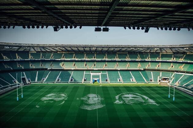 The pitch at Twickenham Stadium has been transformed into a stunning portrait featuring three of Premiership Rugby?s star players today (12th August 2020). The giant rugby art, the largest outdoor painting ever created in the UK, was unveiled to celebrate the restart of Gallagher Premiership Rugby on Friday 14 th August when Harlequins take on Sale Sharks at 7:45pm, just 200 metres away. The artwork features Harlequins player, Joe Marler; Saracens? Maro Itoje, as well as Sale Sharks? Rugby World Cup winner Faf de Klerk. It took team of eight artists more than 24 hours to complete the pitch portrait and more than 100 hours of planning before any paint touched the grass. A bespoke computer program was written to generate the precise measurements that were needed to create the artwork to the exact scale of the stadium. The image, which occupies most of the 7,000 square metre pitch, was created using a grid comprised of 13,420 elements. Each painted line in the portrait is just 6 inches wide. Nearly 1280 litres of biodegradable pitch marker paint were used for the elaborate creation. An estimated 150,000 passengers will enjoy the spectacle from the sky this week on flights in and out of London?s Heathrow airport. Faf de Klerk was one of the featured Premiership Rugby stars in the portrait. The Sale Sharks star said, I didn t realise it was going to be on the field, I thought it was going to be a photo up somewhere or on the big screen. It s looking really cool. There are a lot of great players in the Premiership, and it is amazing. I feel really privileged and quite humble . Speaking about the impact of lockdown on the Saracens star Maro Itoje said The last few months have been really tough on fans and players but we?re back and we?re ready for the start of the season on Friday 14th August. The past five months has shown us how important the sport is and what it brings to people lives. British artist John Lundberg, who oversaw the po Copyright: xScottxGarfitt PinPep CoverxImagesx 0103040087st EDITORIAL USE ONLY. RESTRICTED TO NEWSPAPERS BASED IN THE UK