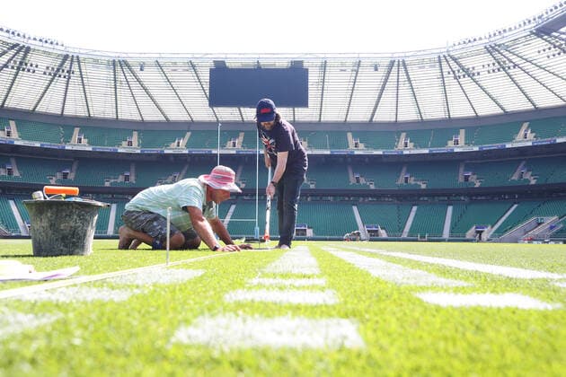 The pitch at Twickenham Stadium has been transformed into a stunning portrait featuring three of Premiership Rugby?s star players today (12th August 2020). The giant rugby art, the largest outdoor painting ever created in the UK, was unveiled to celebrate the restart of Gallagher Premiership Rugby on Friday 14 th August when Harlequins take on Sale Sharks at 7:45pm, just 200 metres away. The artwork features Harlequins player, Joe Marler; Saracens? Maro Itoje, as well as Sale Sharks? Rugby World Cup winner Faf de Klerk. It took team of eight artists more than 24 hours to complete the pitch portrait and more than 100 hours of planning before any paint touched the grass. A bespoke computer program was written to generate the precise measurements that were needed to create the artwork to the exact scale of the stadium. The image, which occupies most of the 7,000 square metre pitch, was created using a grid comprised of 13,420 elements. Each painted line in the portrait is just 6 inches wide. Nearly 1280 litres of biodegradable pitch marker paint were used for the elaborate creation. An estimated 150,000 passengers will enjoy the spectacle from the sky this week on flights in and out of London?s Heathrow airport. Faf de Klerk was one of the featured Premiership Rugby stars in the portrait. The Sale Sharks star said, I didn t realise it was going to be on the field, I thought it was going to be a photo up somewhere or on the big screen. It s looking really cool. There are a lot of great players in the Premiership, and it is amazing. I feel really privileged and quite humble . Speaking about the impact of lockdown on the Saracens star Maro Itoje said The last few months have been really tough on fans and players but we?re back and we?re ready for the start of the season on Friday 14th August. The past five months has shown us how important the sport is and what it brings to people lives. British artist John Lundberg, who oversaw the po Copyright: xScottxGarfitt PinPep CoverxImagesx 0103040125st EDITORIAL USE ONLY. RESTRICTED TO NEWSPAPERS BASED IN THE UK