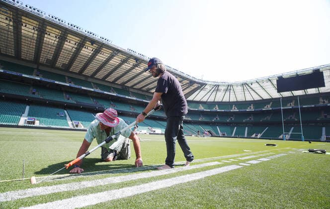 The pitch at Twickenham Stadium has been transformed into a stunning portrait featuring three of Premiership Rugby?s star players today (12th August 2020). The giant rugby art, the largest outdoor painting ever created in the UK, was unveiled to celebrate the restart of Gallagher Premiership Rugby on Friday 14 th August when Harlequins take on Sale Sharks at 7:45pm, just 200 metres away. The artwork features Harlequins player, Joe Marler; Saracens? Maro Itoje, as well as Sale Sharks? Rugby World Cup winner Faf de Klerk. It took team of eight artists more than 24 hours to complete the pitch portrait and more than 100 hours of planning before any paint touched the grass. A bespoke computer program was written to generate the precise measurements that were needed to create the artwork to the exact scale of the stadium. The image, which occupies most of the 7,000 square metre pitch, was created using a grid comprised of 13,420 elements. Each painted line in the portrait is just 6 inches wide. Nearly 1280 litres of biodegradable pitch marker paint were used for the elaborate creation. An estimated 150,000 passengers will enjoy the spectacle from the sky this week on flights in and out of London?s Heathrow airport. Faf de Klerk was one of the featured Premiership Rugby stars in the portrait. The Sale Sharks star said, I didn t realise it was going to be on the field, I thought it was going to be a photo up somewhere or on the big screen. It s looking really cool. There are a lot of great players in the Premiership, and it is amazing. I feel really privileged and quite humble . Speaking about the impact of lockdown on the Saracens star Maro Itoje said The last few months have been really tough on fans and players but we?re back and we?re ready for the start of the season on Friday 14th August. The past five months has shown us how important the sport is and what it brings to people lives. British artist John Lundberg, who oversaw the po Copyright: xScottxGarfitt PinPep CoverxImagesx 0103040130st EDITORIAL USE ONLY. RESTRICTED TO NEWSPAPERS BASED IN THE UK