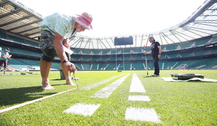 The pitch at Twickenham Stadium has been transformed into a stunning portrait featuring three of Premiership Rugby?s star players today (12th August 2020). The giant rugby art, the largest outdoor painting ever created in the UK, was unveiled to celebrate the restart of Gallagher Premiership Rugby on Friday 14 th August when Harlequins take on Sale Sharks at 7:45pm, just 200 metres away. The artwork features Harlequins player, Joe Marler; Saracens? Maro Itoje, as well as Sale Sharks? Rugby World Cup winner Faf de Klerk. It took team of eight artists more than 24 hours to complete the pitch portrait and more than 100 hours of planning before any paint touched the grass. A bespoke computer program was written to generate the precise measurements that were needed to create the artwork to the exact scale of the stadium. The image, which occupies most of the 7,000 square metre pitch, was created using a grid comprised of 13,420 elements. Each painted line in the portrait is just 6 inches wide. Nearly 1280 litres of biodegradable pitch marker paint were used for the elaborate creation. An estimated 150,000 passengers will enjoy the spectacle from the sky this week on flights in and out of London?s Heathrow airport. Faf de Klerk was one of the featured Premiership Rugby stars in the portrait. The Sale Sharks star said, I didn t realise it was going to be on the field, I thought it was going to be a photo up somewhere or on the big screen. It s looking really cool. There are a lot of great players in the Premiership, and it is amazing. I feel really privileged and quite humble . Speaking about the impact of lockdown on the Saracens star Maro Itoje said The last few months have been really tough on fans and players but we?re back and we?re ready for the start of the season on Friday 14th August. The past five months has shown us how important the sport is and what it brings to people lives. British artist John Lundberg, who oversaw the po Copyright: xScottxGarfitt PinPep CoverxImagesx 0103040131st EDITORIAL USE ONLY. RESTRICTED TO NEWSPAPERS BASED IN THE UK