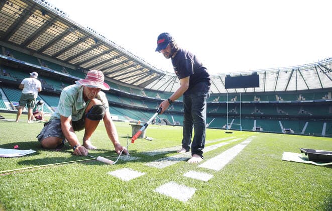 The pitch at Twickenham Stadium has been transformed into a stunning portrait featuring three of Premiership Rugby?s star players today (12th August 2020). The giant rugby art, the largest outdoor painting ever created in the UK, was unveiled to celebrate the restart of Gallagher Premiership Rugby on Friday 14 th August when Harlequins take on Sale Sharks at 7:45pm, just 200 metres away. The artwork features Harlequins player, Joe Marler; Saracens? Maro Itoje, as well as Sale Sharks? Rugby World Cup winner Faf de Klerk. It took team of eight artists more than 24 hours to complete the pitch portrait and more than 100 hours of planning before any paint touched the grass. A bespoke computer program was written to generate the precise measurements that were needed to create the artwork to the exact scale of the stadium. The image, which occupies most of the 7,000 square metre pitch, was created using a grid comprised of 13,420 elements. Each painted line in the portrait is just 6 inches wide. Nearly 1280 litres of biodegradable pitch marker paint were used for the elaborate creation. An estimated 150,000 passengers will enjoy the spectacle from the sky this week on flights in and out of London?s Heathrow airport. Faf de Klerk was one of the featured Premiership Rugby stars in the portrait. The Sale Sharks star said, I didn t realise it was going to be on the field, I thought it was going to be a photo up somewhere or on the big screen. It s looking really cool. There are a lot of great players in the Premiership, and it is amazing. I feel really privileged and quite humble . Speaking about the impact of lockdown on the Saracens star Maro Itoje said The last few months have been really tough on fans and players but we?re back and we?re ready for the start of the season on Friday 14th August. The past five months has shown us how important the sport is and what it brings to people lives. British artist John Lundberg, who oversaw the po Copyright: xScottxGarfitt PinPep CoverxImagesx 0103040132st EDITORIAL USE ONLY. RESTRICTED TO NEWSPAPERS BASED IN THE UK