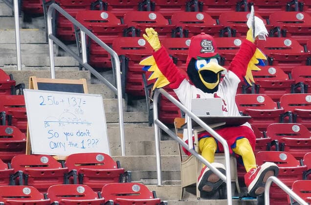St. Louis Cardinals mascot Fredbird does some home schooling on the first day of school in St. Louis as he watches the Kansas City Royals take on the St. Louis Cardinals at Busch Stadium in St. Louis on Monday, August 24, 2020.  SLP2020082403 BILLxGREENBLATT
