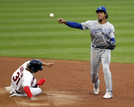Kansas City Royals Adalberto Mondesi (27) throws to first to complete a double play as Cleveland Indians Josh Naylor (31) slides into second base in the second inning at Progressive Field in Cleveland, Ohio on Monday, September 7, 2020.  CLE20200907113 AARONxJOSEFCZYK