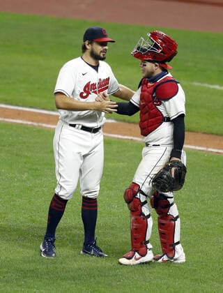 Cleveland Indians Brad Hand (33) is congratulated by catcher Roberto Pérez after the Indians defeated the Kansas City Royals at Progressive Field in Cleveland, Ohio on Monday, September 7, 2020.  CLE20200907121 AARONxJOSEFCZYK