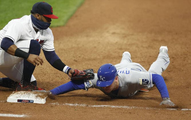 Kansas City Royals Ryan O Hearn (66) dives back to first base ahead of the tag from Cleveland Indians Carlos Santana in the fourth inning at Progressive Field in Cleveland, Ohio on Monday, September 7, 2020.  CLE20200907114 AARONxJOSEFCZYK