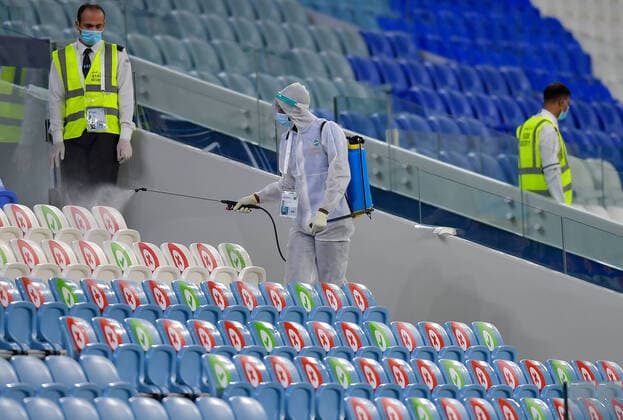 (200918) -- DOHA, Sept. 18, 2020 -- An employee wearing personal protective equipment (PPE) disinfects the players bench inside Al-Janoub Stadium to prevent the spread of the COVID-19, prior to the 2020 AFC Champions League group B soccer match between Pakhtakor of Uzbekistan and Al Hilal SFC of Saudi Arabia in Doha, capital of Qatar, Sept. 17, 2020. (Photo by Xinhua) (SP)QATAR-DOHA-FOOTBALL-AFC CHAMPIONS LEAGUE Nikku 