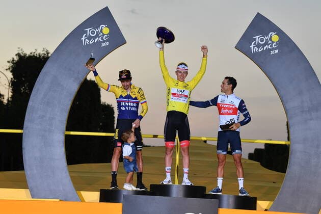 L-R, second Primoz Roglic of Team Jumbo - Visma (and his child), winner yellow jersey Slovenian Tadej Pogacar of UAE Team Emirates and third Richie Porte of Trek - Segafredo, celebrate on the podium after the final stage of the 107th edition of the Tour de France cycling race, 122km from Mantes-la-Jolie to Paris, in France, Sunday 20 September 2020. This year s Tour de France was postponed due to the worldwide Covid-19 pandemic. The 2020 race starts in Nice on Saturday 29 August and ends on 20 September. DAVIDxSTOCKMAN  x2548238x