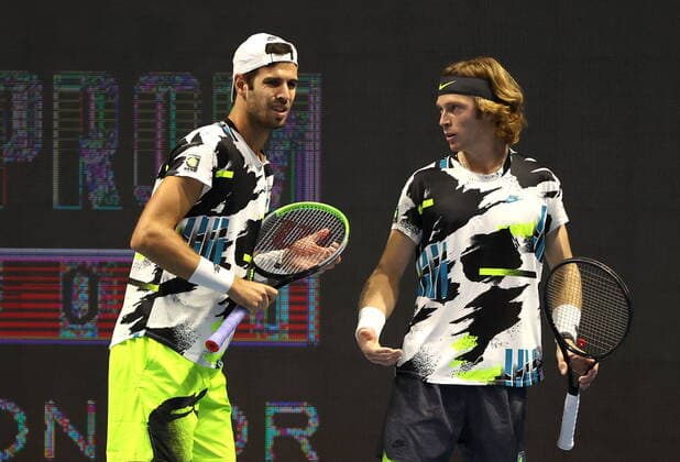 ST PETERSBURG, RUSSIA - OCTOBER 14, 2020: Russian tennis players Karen Khachanov (L) and Andrei Rublev struggle in a men s doubles quarter-final match against their rivals Alexander Bublik of Kazakhstan and Reilly Opelka of the US during the St Petersburg Open 2020 international tournament held at Sibur Arena. Alexander Demianchuk TASS  TS0EAD2C