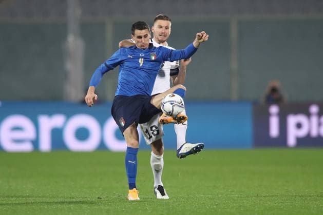Kevin Lasagna of Italy controls the ball under pressure from Karol Mets of Estonia during the International Friendly, Länderspiel, Nationalmannschaft match at Stadio Artemio Franchi, Florence. Picture date: 11th November 2020. Picture credit should read: Jonathan Moscrop Sportimage EDITORIAL USE ONLY. No use with unauthorised audio, video, data, fixture lists, club league logos or live services. Online in-match use limited to 120 images, no video emulation. No use in betting, games or single club league player publications. SPI-0747-0024