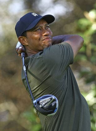 Golf: Masters Tournament Defending champion Tiger Woods hits a tee shot on the ninth hole during the first round of the Masters Tournament at Augusta National Golf Club in Augusta, Georgia, on Nov. 12, 2020. 