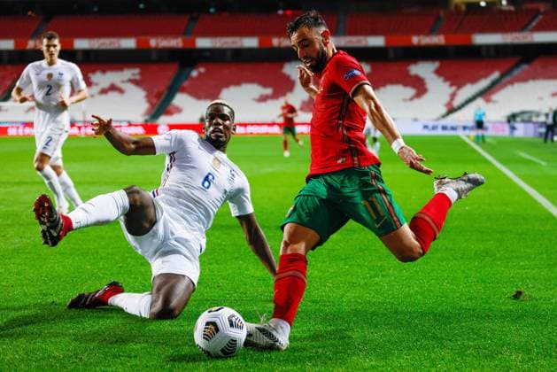 14th November 2020, The Est& xe1;dio da Luz, Lisbon, Portugal; Nations League International football, Portugal versus France; Bruno Fernandes of Portugal crosses as Paul Pogba of France comes in to attempt to block  ActionPlus12247190 DiogoxPinto
