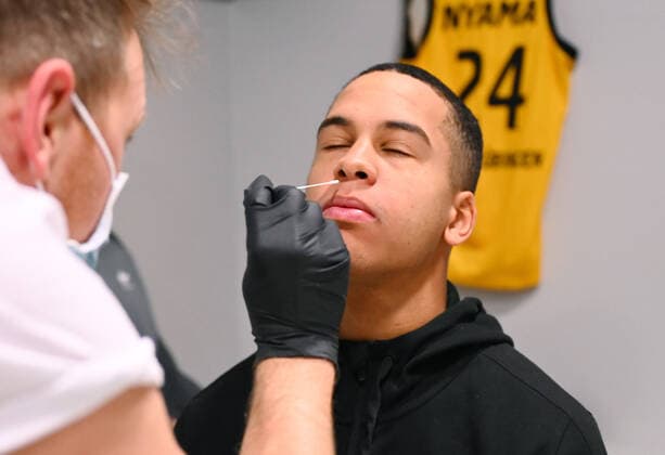 Basketball 2 Bundesliga 2020 2021 9 Matchday 05 12 2020 Tigers Tuebingen Rostock Seawolves Tigers Team doctor Philipp Calgeer li takes a sample from Mirjan Broening Tigers for a Corona rapid test