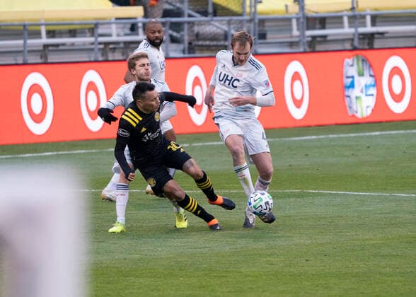 COLUMBUS, OH - DECEMBER 06: New England Revolution defender Henry Kessler 4 tips up Columbus Crew SC midfielder Lucas Zelarrayan 10 as he controls the ball during the Eastern Conference Final between the Columbus Crew SC and the New England Revolution at MAPFRE Stadium in Columbus, Oho on December 6th, 2020. (Photo by Jason Mowry Icon Sportswire) SOCCER: DEC 06 MLS, Fussball Herren, USA Cup Playoffs Eastern Conference Final - New England Revolution at Columbus Crew Icon2012060017