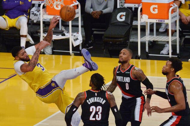 Los Angeles Lakers Anthony Davis loses the ball and his balance against the Portland Trail Blazers during the second half at Staples Center in Los Angeles on Monday, December 28, 2020. The Trail Blazers defeated the Lakers 115-107.  LAP2020122819 JIMxRUYMEN