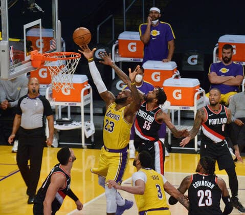 Los Angeles Lakers LeBron James scores past Portland Trail Blazers Derrick Jones Jr. during the second half at Staples Center in Los Angeles on Monday, December 28, 2020. The Trail Blazers defeated the Lakers 115-107.  LAP2020122804 JIMxRUYMEN
