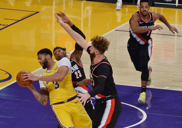 Los Angeles Lakers Anthony Davis is double-teamed by Portland Trail Blazers Robert Covington and Jusuf Nurkic during the second half at Staples Center in Los Angeles on Monday, December 28, 2020. The Trail Blazers defeated the Lakers 115-107.  LAP2020122806 JIMxRUYMEN
