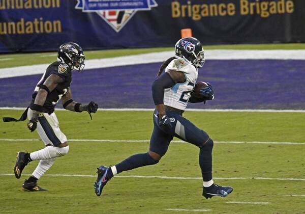 January 9, 2021, USA: Titans Derrick Henry, right, runs away from Ravens DeShon Elliott, left, for a 29-yards game-winning touchdown in overtime. The Titans defeated the Ravens by score of 30-24 in overtime at M & T Bank Stadium on Nov. 22, 2020. USA - ZUMAm67_ 20210109_zaf_m67_019 Copyright: xKennethxK.xLamx xBaltimorexSunx