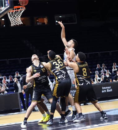 Benedikt Turudic Syntainics MBC successfully wins against James Robinson Basketball Loewen Braunschweig , Karim Jallow Basketball Loewen Braunschweig and Martin Peterka Basketball Loewen Braunschweig