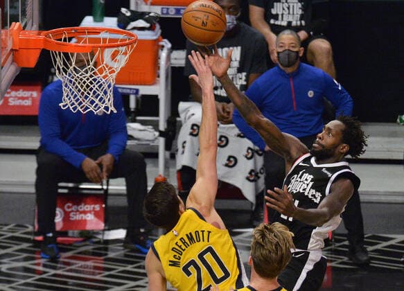 Los Angeles Clippers guard Patrick Beverley scores as he is fouled by Indiana Pacers forward Doug McDermott on his way to the basket during the fourth quarter at Staples Center in Los Angeles on Sunday, January 17, 2021. The Clippers defeated the short-handed Pacers 129-96.  LAP2021011713 JIMxRUYMEN