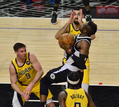 Los Angeles Clippers guard Reggie Jackson splits the Indiana Pacers defenders on his way to the basket during the fourth quarter at Staples Center in Los Angeles on Sunday, January 17, 2021. The Clippers defeated the short-handed Pacers 129-96.  LAP2021011715 JIMxRUYMEN
