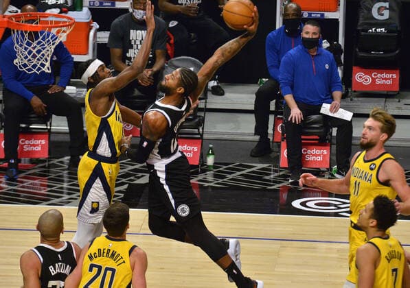 Los Angeles Clippers forward Paul George scores over Indiana Pacers point guard Justin Holiday during the second quarter at Staples Center in Los Angeles on Sunday, January 17, 2021. The Clippers defeated the short-handed Pacers 129-96.  LAP2021011722 JIMxRUYMEN