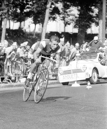 Jacques Anquetil FRA in action on 25 06 1961 during the Tour de France time trial in Versaille, behind him his support car HM