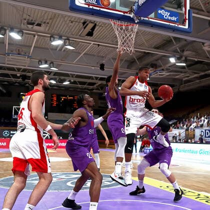 GSD zje123 season 2020 21 Easy credit Basketball Bundesliga BG Göttingen Brose Bamberg Bambergs Devon Hall on the ball against Göttingens Aubrey Dawkins and Tai Odiase left.