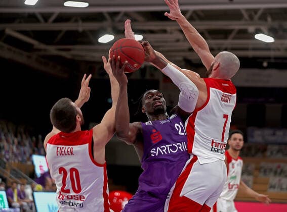 GSD zje123 Season 2020 21 Easy credit Basketball Bundesliga BG Göttingen Brose Bamberg Göttingens Tai Odiase on the ball against Bambergs Shase Fieler left and Alex Ruoff right.