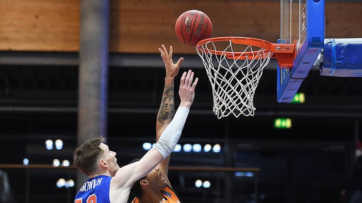 Basketball 1 Bundesliga, Season 2020 2021, 15 Matchday, Syntainics MBC Weissenfels vs ratiopharm Ulm 30 01 2021 Duel for the ball at the basket between Philpp Hartwich MBC Weissenfels, back number 12 and Isaiah Wilkins Forward ratiopharm Ulm, back number 11 during the match MBC Weissenfels vs Ulm 30 01 2021 Weissenfels Saxony Anhalt Germany Stadthalle Weissenfels