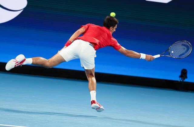 (210205) -- MELBOURNE, Feb. 5, 2021 -- Serbia s Novak Djokovic returns the ball against Germany s Alexander Zverev during the ATP, Tennis Herren Cup group A match between Serbia and Germany in Melbourne, Australia, on Feb. 5, 2021. ) (SP)AUSTRALIA-MELBOURNE-TENNIS-ATP CUP-GROUP A-SERBIA VS GERMANY BaixXuefei 