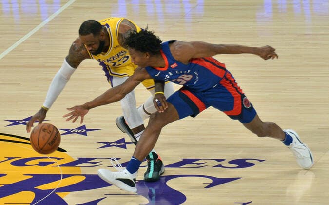 Los Angeles Lakers forward LeBron James and Detroit Pistons point guard Saben Lee chase the loose ball during the third quarter at Staples Center in Los Angeles on Saturday, February 6, 2021. The Lakers defeated the Pistons 135-129 in double-overtime.  LAP2021020621 JIMxRUYMEN