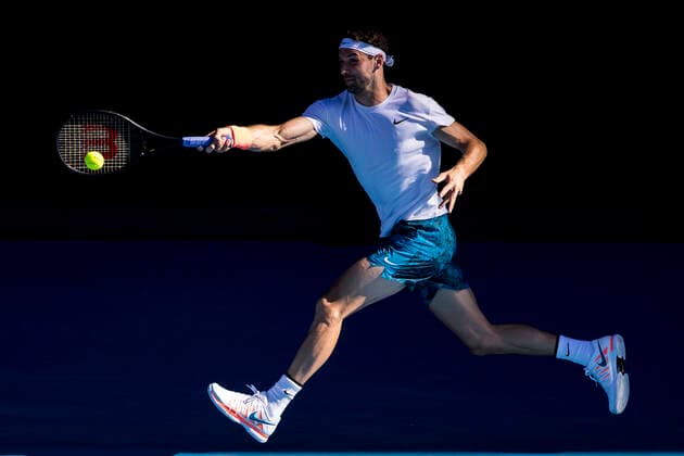 MELBOURNE, VIC - FEBRUARY 14: Grigor Dimitrov of Bulgaria returns the ball during round 4 of the 2021 Australian Open on February 14 2020, at Melbourne Park in Melbourne, Australia. (Photo by Jason Heidrich Icon Sportswire) TENNIS: FEB 14 Australian Open Icon2102141427