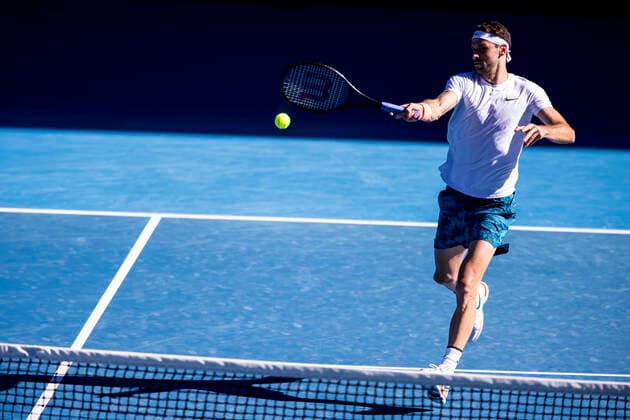 MELBOURNE, VIC - FEBRUARY 14: Grigor Dimitrov of Bulgaria returns the ball during round 4 of the 2021 Australian Open on February 14 2020, at Melbourne Park in Melbourne, Australia. (Photo by Jason Heidrich Icon Sportswire) TENNIS: FEB 14 Australian Open Icon2102141457