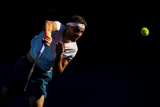 MELBOURNE, VIC - FEBRUARY 14: Grigor Dimitrov of Bulgaria serves the ball during round 4 of the 2021 Australian Open on February 14 2020, at Melbourne Park in Melbourne, Australia. (Photo by Jason Heidrich Icon Sportswire) TENNIS: FEB 14 Australian Open Icon2102141527