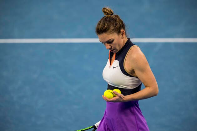 MELBOURNE, VIC - FEBRUARY 14: Simona Halep of Romania prepares to serve the ball during round 4 of the 2021 Australian Open on February 14 2020, at Melbourne Park in Melbourne, Australia. (Photo by Jason Heidrich Icon Sportswire) TENNIS: FEB 14 Australian Open Icon2102141767