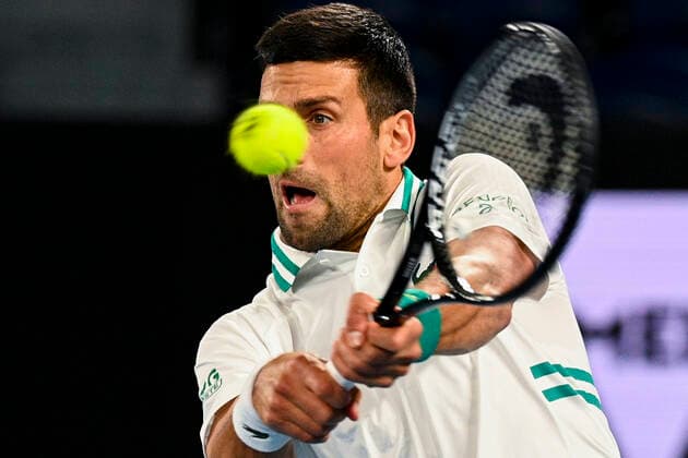 TENNIS AUSTRALIAN OPEN, Novak Djokovic of Serbia in action during his fourth Round Men s singles match against Milos Raonic of Canada on Day 7 of the Australian Open at Melbourne Park in Melbourne, Sunday, February 14, 2021. ( NO ARCHIVING, EDITORIAL USE ONLY, NO USE IN BOOKS WITHOUT CONSENT MELBOURNE VIC AUSTRALIA  Copyright: xDEANxLEWINSx 20210214001520519047